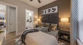 Richardson apartment for rent - A bedroom with a large bed and a ceiling fan.