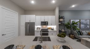 Richardson apartment for rent - A modern kitchen with a dining table set for four.