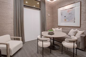 Richmond apartment for rent - A modern living room with a grey sofa, a round table, and a painting on the wall.