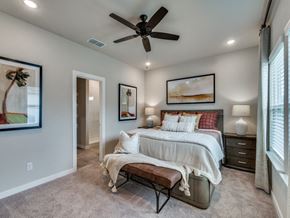 Fort Worth triplex for rent - A bedroom with a bed, bench, and artwork on the wall.