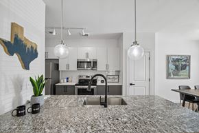 Leander apartment for rent - A kitchen with a granite countertop and a sink.