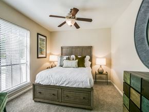 Houston apartment for rent - a bedroom with a bed and a ceiling fan