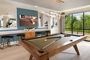 Houston apartment for rent - A pool table is in the middle of a room with a bar and a window.