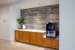 Houston apartment for rent - A modern kitchen with wooden cabinets and a stone backsplash.