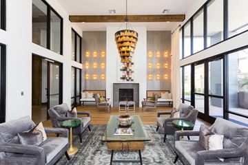 Chandler apartment for rent - A modern living room with grey couches and a fireplace.