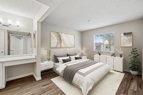 Auburn apartment for rent - A bedroom with a large bed and a mirrored dresser.