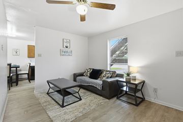 Stephenville apartment for rent - A living room with a black couch and a coffee table.