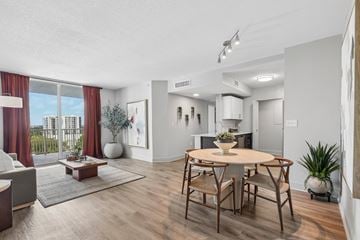 Miami apartment for rent - A modern living room with a dining table and chairs.
