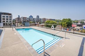 Durham apartment for rent - a pool on the roof of a building with a city in the background