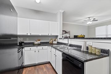 Tyler apartment for rent - the preserve at ballantyne commons apartment kitchen with granite counter tops and white cabinets