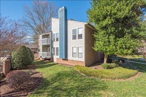 Raleigh apartment for rent - a blue and white apartment building with a tree in front of it