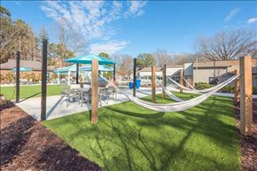 Raleigh apartment for rent - a playground with hammocks and tables and umbrellas