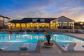 Fort Worth apartment for rent - A pool with a building behind it.