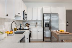 Huntsville apartment for rent - A modern kitchen with white cabinets and a stainless steel refrigerator.