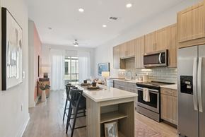 Plano apartment for rent - A modern kitchen with a dining table and chairs.