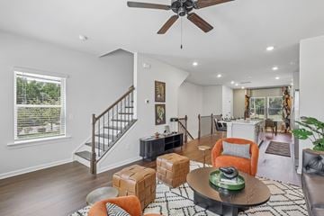 Charlotte townhouse for rent - A living room with a brown coffee table and orange chairs.