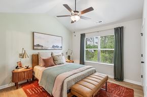 Charlotte townhouse for rent - A bedroom with a bed, nightstand, and window.