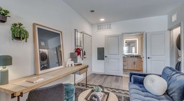 Austin apartment for rent - A living room with a blue couch and a wooden table.