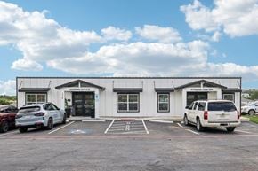 Harker Heights townhouse for rent - A white building with a sign that says "Fitness Center" is in front of a blue sky with clouds.