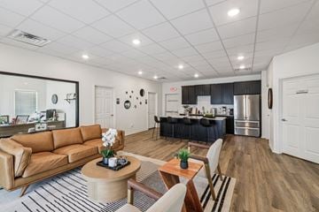 Harker Heights townhouse for rent - A modern living room with a brown leather couch and a wooden coffee table.