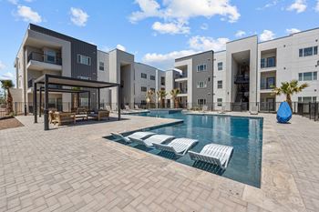 Resort-style pool with cabanas and lawn games