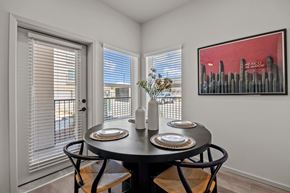 El Paso apartment for rent - a dining room with three windows and a table with plates and chairs