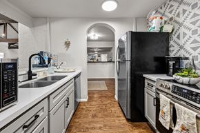 El Paso apartment for rent - A kitchen with a black fridge and stove top oven.