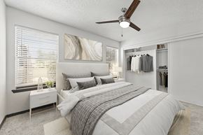 Dallas apartment for rent - A bedroom with a large bed and a ceiling fan.
