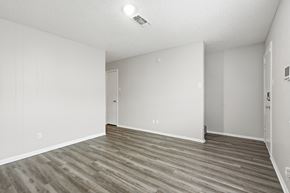 Stephenville apartment for rent - A room with wooden flooring and white walls.