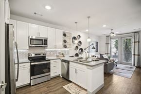 Franklin apartment for rent - A modern kitchen with white cabinets and stainless steel appliances.