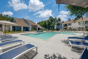 Austin apartment for rent - A sunny day at the pool with lounge chairs and a clear blue sky.