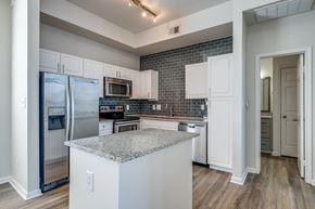 Dallas apartment for rent - a kitchen with stainless steel appliances and a granite counter top