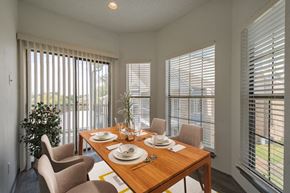 Dallas apartment for rent - a dining room with a wooden table and chairs