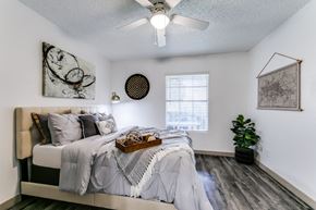 Dallas apartment for rent - an attic bedroom with a bed and a ceiling fan