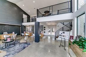 Dallas apartment for rent - the lobby of a building with a staircase and tables and chairs