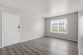 Stephenville apartment for rent - A room with a white door and a window showing a building outside.