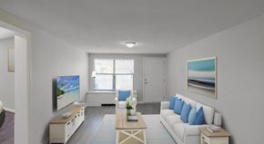 Panama City apartment for rent - a living room with a white couch and a television