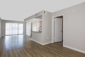 Phoenix apartment for rent - the living room and kitchen of an empty apartment with wood floors and white walls