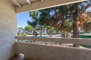 Phoenix apartment for rent - a balcony with a view of a tree and a pool