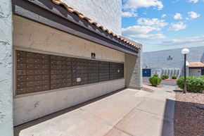 Phoenix apartment for rent - a garage with a white wall and tile roof with a blue sky in the background
