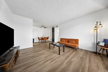 El Paso apartment for rent - A living room with a brown couch and a wooden coffee table.