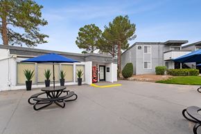 El Paso apartment for rent - A large white building with a blue canopy and a red fire hydrant in front.