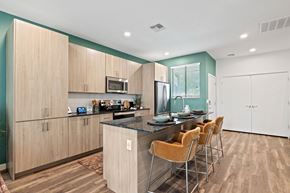 Phoenix apartment for rent - a kitchen with a large island and a bar with chairs