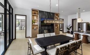 Omaha apartment for rent - A modern dining room with a black table and chairs.