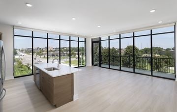 Omaha apartment for rent - A modern kitchen with a sink and a view of the city.