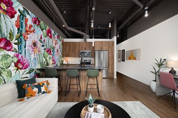 Phoenix apartment for rent - A modern living room with a white sofa and a wooden coffee table.