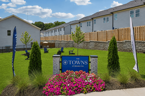 Braselton apartment for rent - A sign that says "The Towns" is in front of a building.