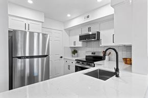 Phoenix apartment for rent - a white kitchen with stainless steel appliances and a sink