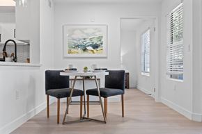 Phoenix apartment for rent - a dining room with a white table and two black chairs