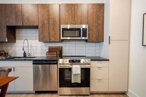 Savannah apartment for rent - A modern kitchen with wooden cabinets and stainless steel appliances.